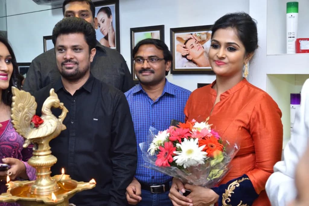Celebrity guest holding a bouquet at an inauguration lamp-lighting ceremony