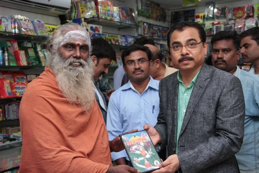 AirMedia representative receiving a gift from a spiritual leader