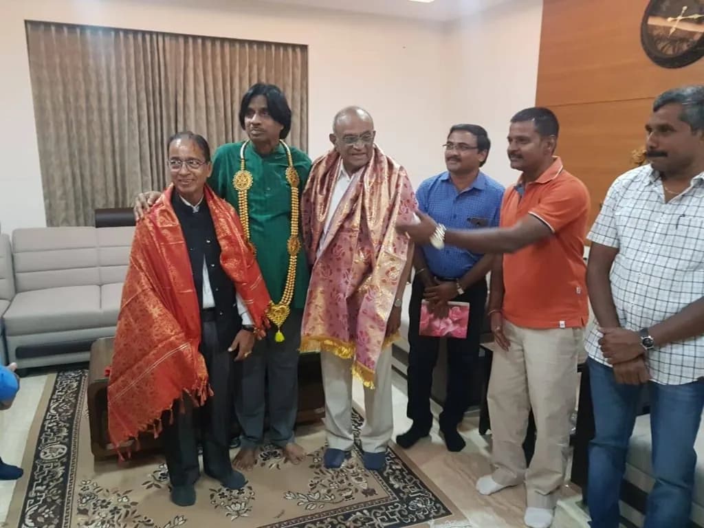 AirMedia team at a ceremonial function with honoured guests wearing shawls
